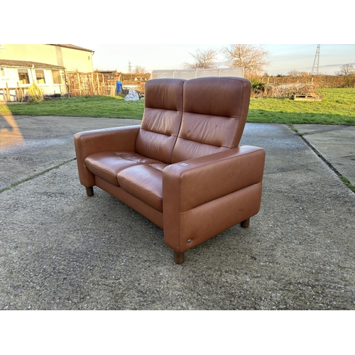 334 - An ekornes stressless brown leather two seater reclining sofa