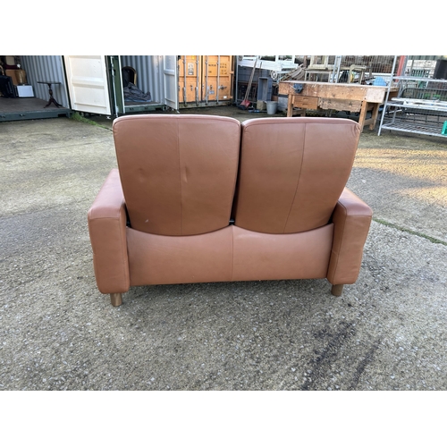 334 - An ekornes stressless brown leather two seater reclining sofa