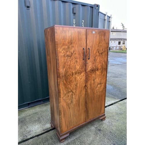 343 - A deco style walnut two door wardrobe part fitted to interior 101x44x180