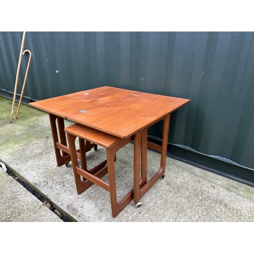 365 - A mid century mcintosh teak nest of three tables with fold over top