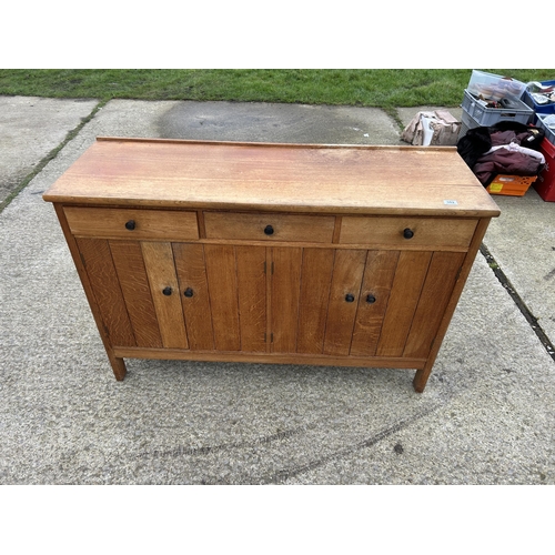 382 - A arts and crafts style oak three drawer sideboard 138x45x90