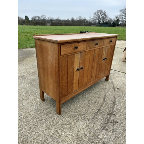 382 - A arts and crafts style oak three drawer sideboard 138x45x90