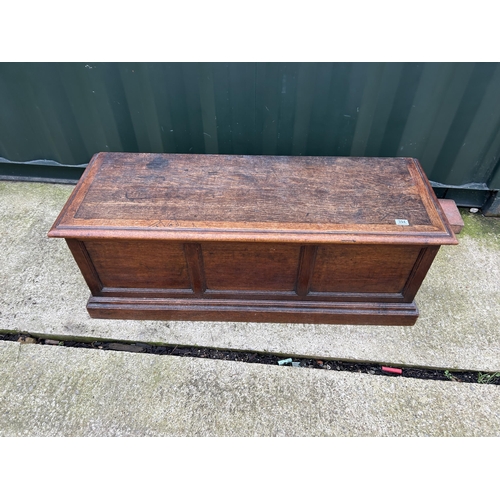 394 - An oak three panel blanket box chest