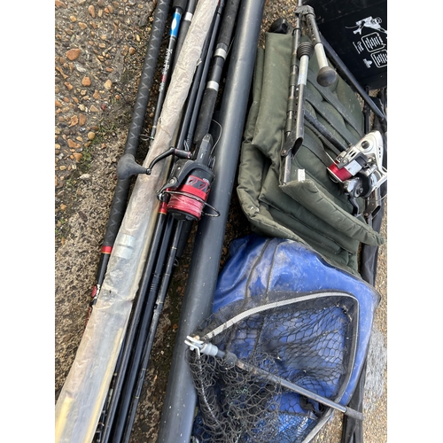 409 - A collection of fishing items including, rods reels, net and folding seat