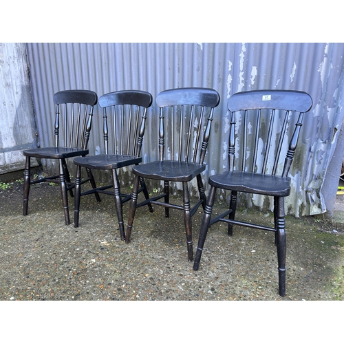 41 - Four black painted stick back chairs