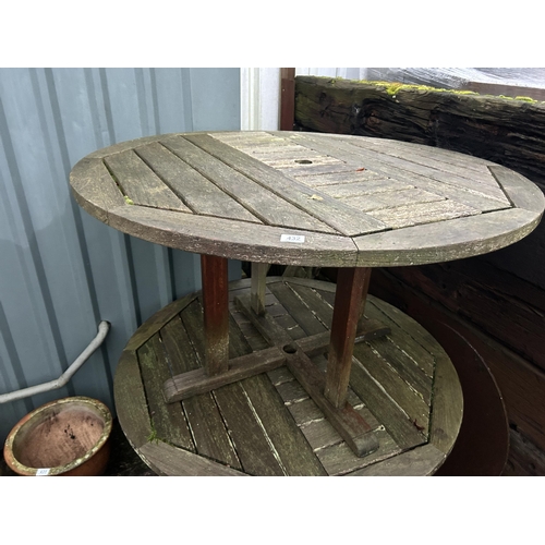 432 - A pair of large circualar hardwood garden tables