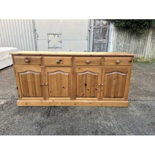 45 - A solid pine four drawer sideboard 182x42x80