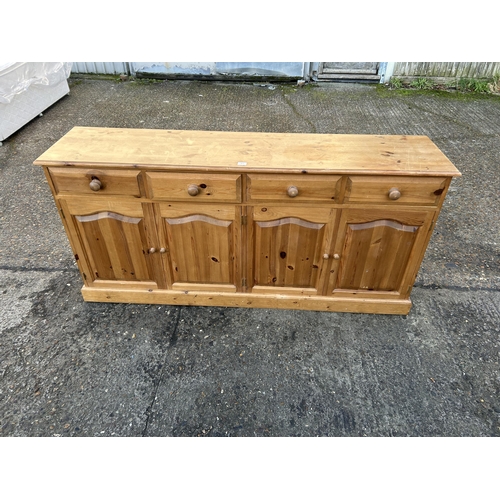 45 - A solid pine four drawer sideboard 182x42x80