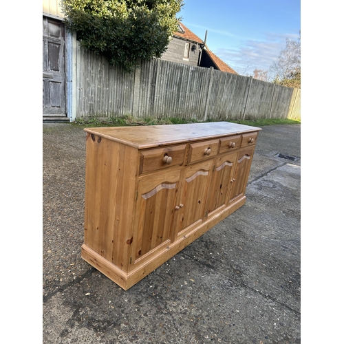 45 - A solid pine four drawer sideboard 182x42x80