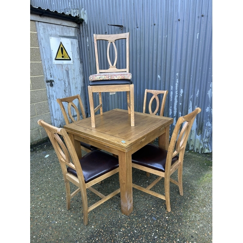 5 - A modern light oak fold over extending table together with five chairs 90x90x78