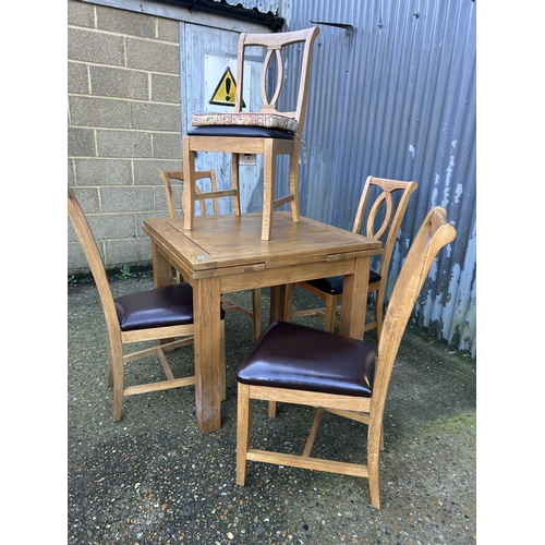 5 - A modern light oak fold over extending table together with five chairs 90x90x78