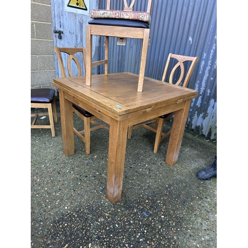 5 - A modern light oak fold over extending table together with five chairs 90x90x78