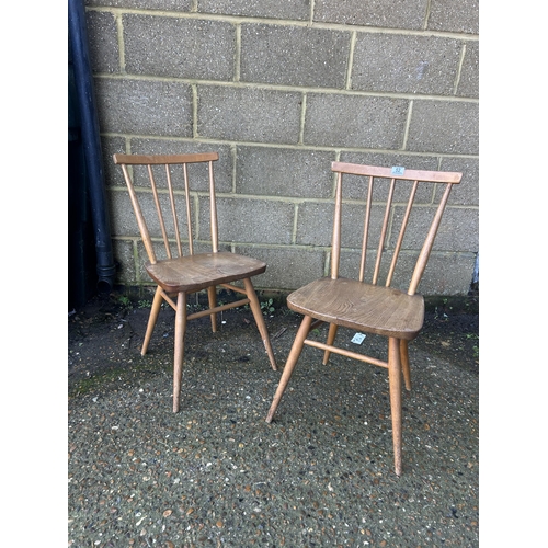 52 - A pair of ercol light elm stick back chairs