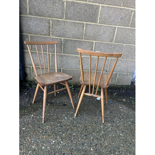 52 - A pair of ercol light elm stick back chairs