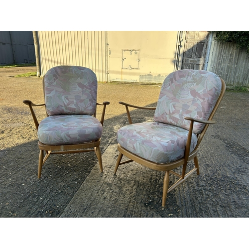 95 - A pair of ercol light elm armchairs