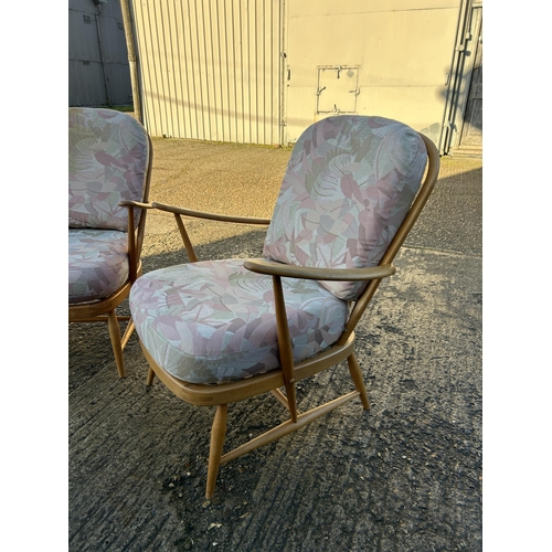 95 - A pair of ercol light elm armchairs