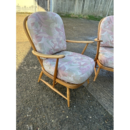 95 - A pair of ercol light elm armchairs