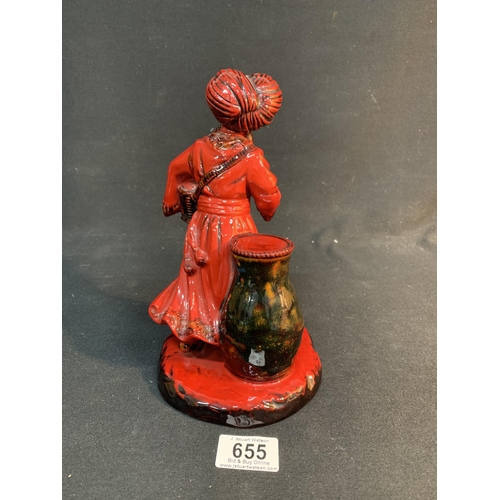 655 - Doulton Flambé The Lamp Seller, height 23 cms, repair to hand holding lamp