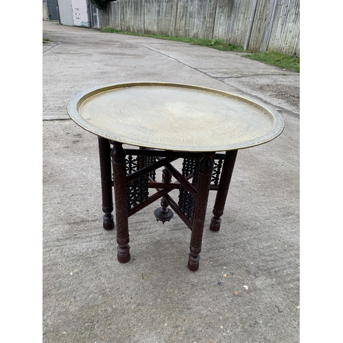 712 - Brass Topped Islamic folding table, diameter of top 70 cms