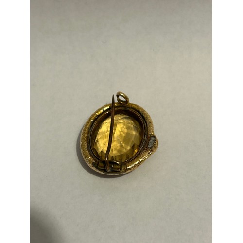 895 - A Victorian gold single stone citrine brooch, an oval cut citrine set to a snake surround with later... 