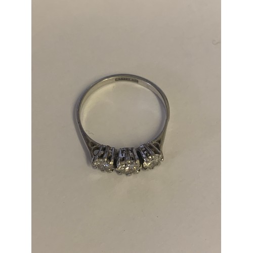 891 - A platinum three stone diamond ring, three brilliant cut diamonds claw set to  chenier shoulders and... 