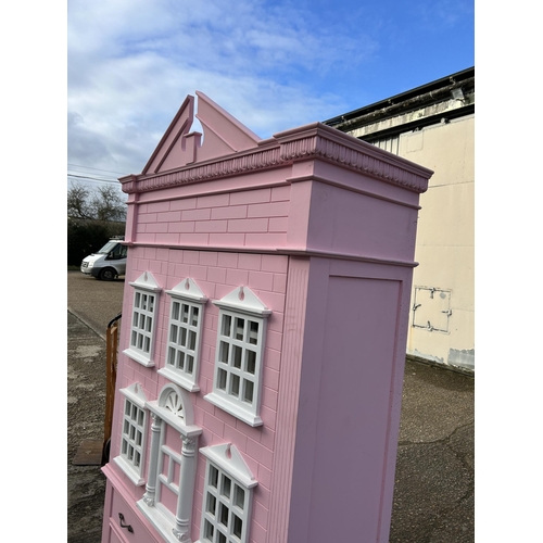 132 - A very large nursery wardrobe, styled as a dolls house 126x40x215