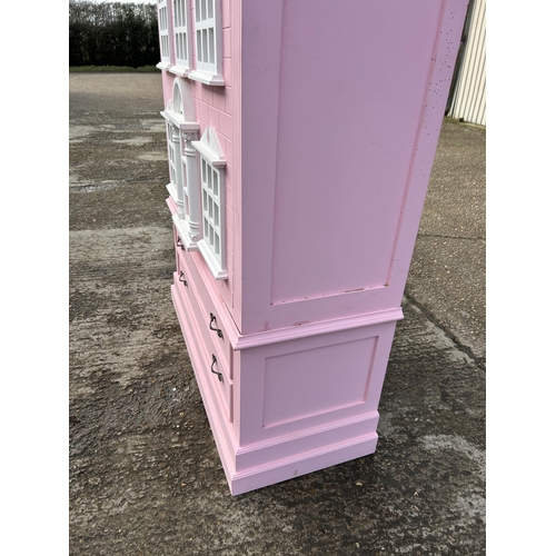 132 - A very large nursery wardrobe, styled as a dolls house 126x40x215