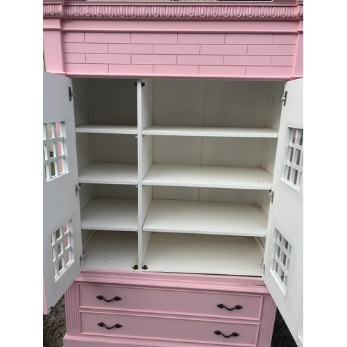 132 - A very large nursery wardrobe, styled as a dolls house 126x40x215