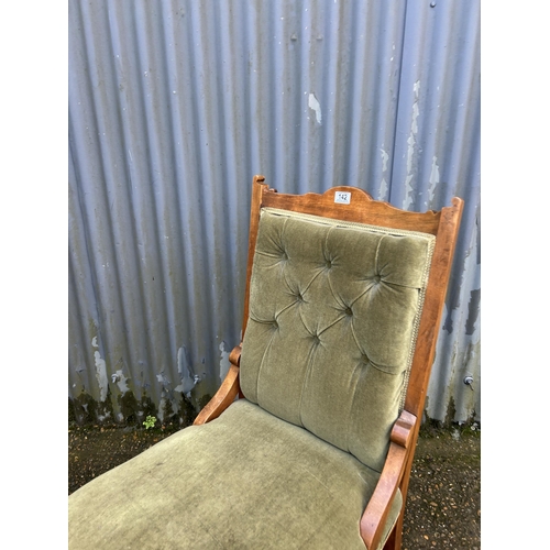 142 - An Edwardian green upholstered chair