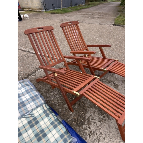 151 - A pair of good quality hardwood steamer style lounger chairs with cushions