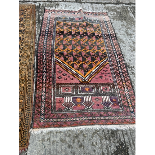 154 - A red oriental pattern rug together with a gold pattern rug (Largest)130x190