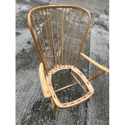 161 - An ercol light elm stick back armchair, recently refurbished, requires webbing