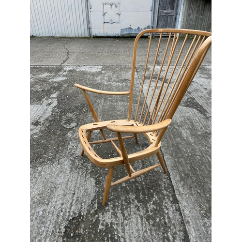 161 - An ercol light elm stick back armchair, recently refurbished, requires webbing