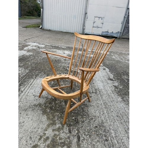 162 - An ercol light elm stick back armchair, recently refurbished, requires webbing