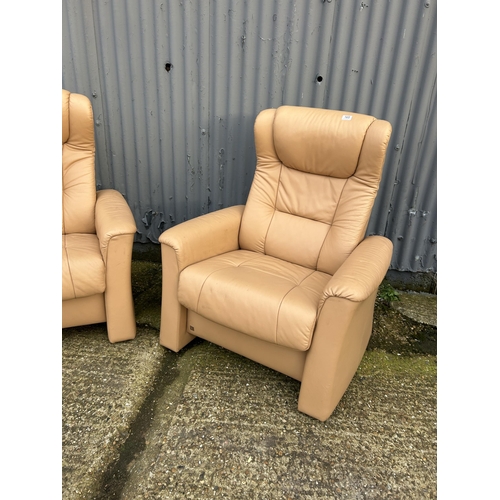 165 - A pair of FJORDS cream leather reclining armchairs