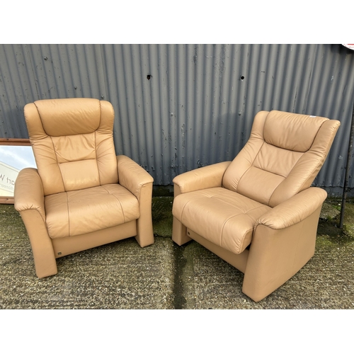 165 - A pair of FJORDS cream leather reclining armchairs