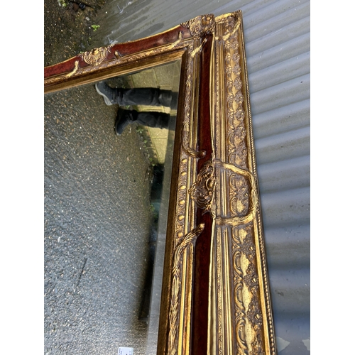 190 - A highly ornate gold gilt framed mirror 128x100