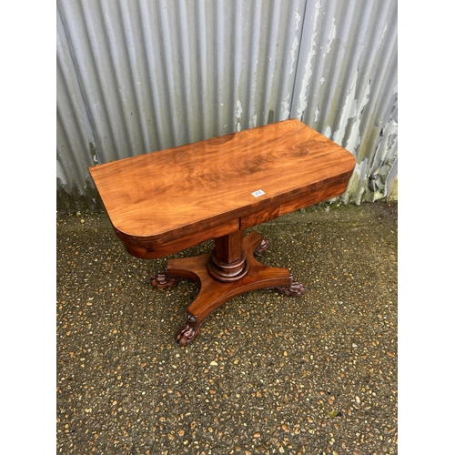 205 - A Victorian mahogany fold over card table with green baize surface