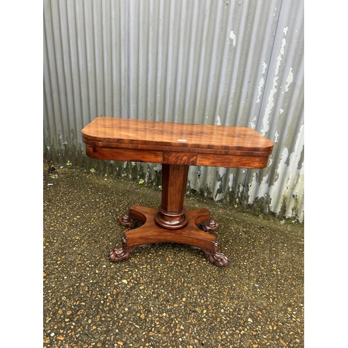 205 - A Victorian mahogany fold over card table with green baize surface