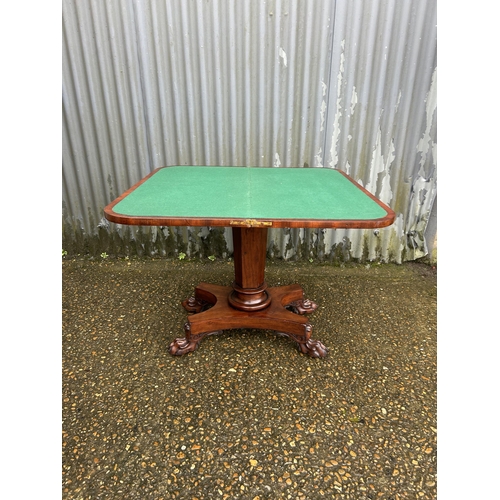 205 - A Victorian mahogany fold over card table with green baize surface