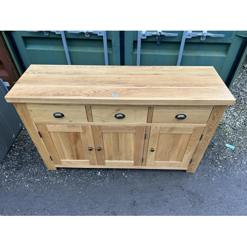 23 - A modern light oak three drawer sideboard 140 x44x85