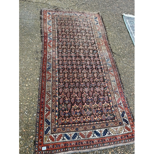 272 - A red and brown oriental pattern rug together with a green pattern rug, Largest 117x245