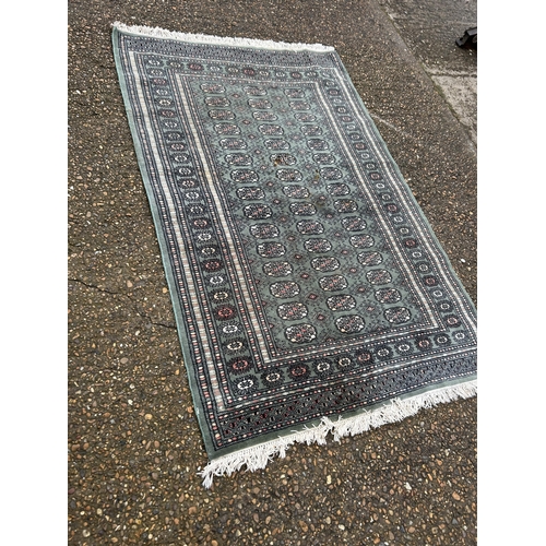 272 - A red and brown oriental pattern rug together with a green pattern rug, Largest 117x245