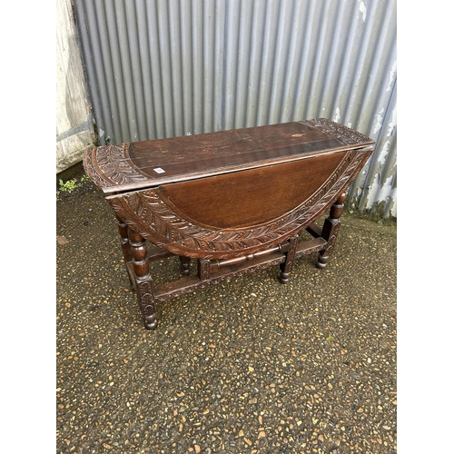 283 - A large antique carved oak gateleg table 120cm diameter