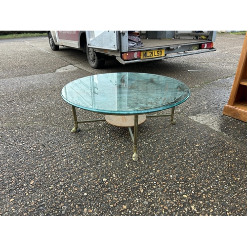 293 - A heavy brass circular coffee table with thick glass top 105cm diameter