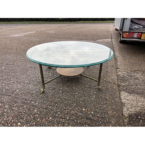 293 - A heavy brass circular coffee table with thick glass top 105cm diameter