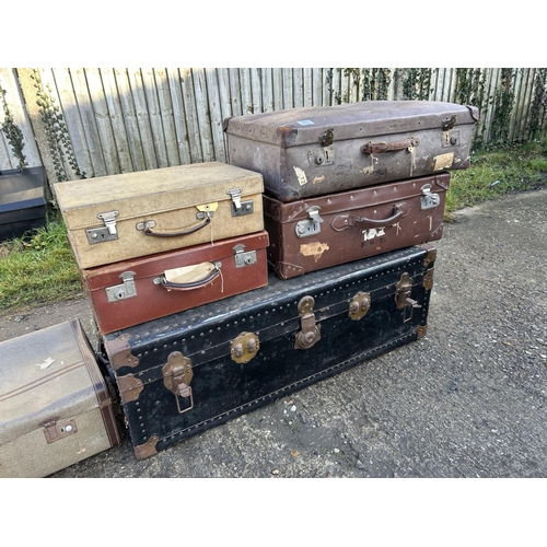 303 - A large trunk and five vintage suitcases