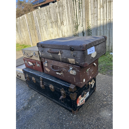 303 - A large trunk and five vintage suitcases