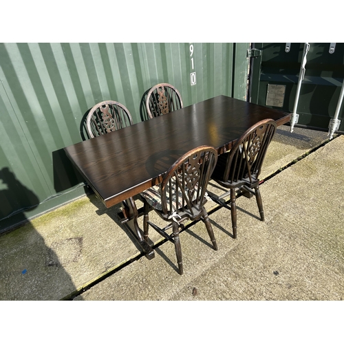 306 - An oak refectory style dining table together with four wheelback chairs 152x72