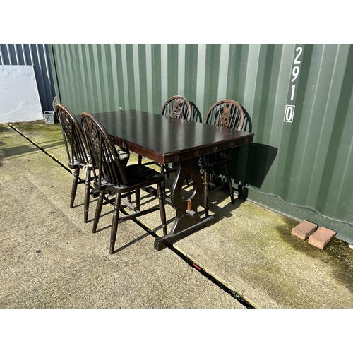 306 - An oak refectory style dining table together with four wheelback chairs 152x72